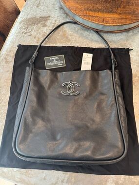 CHANEL Black Leather Bag with Blue CC Logo Accent